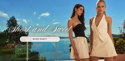 2 girls standing outdoors with ocean view in the background. Short and Sweet. Shop Party.